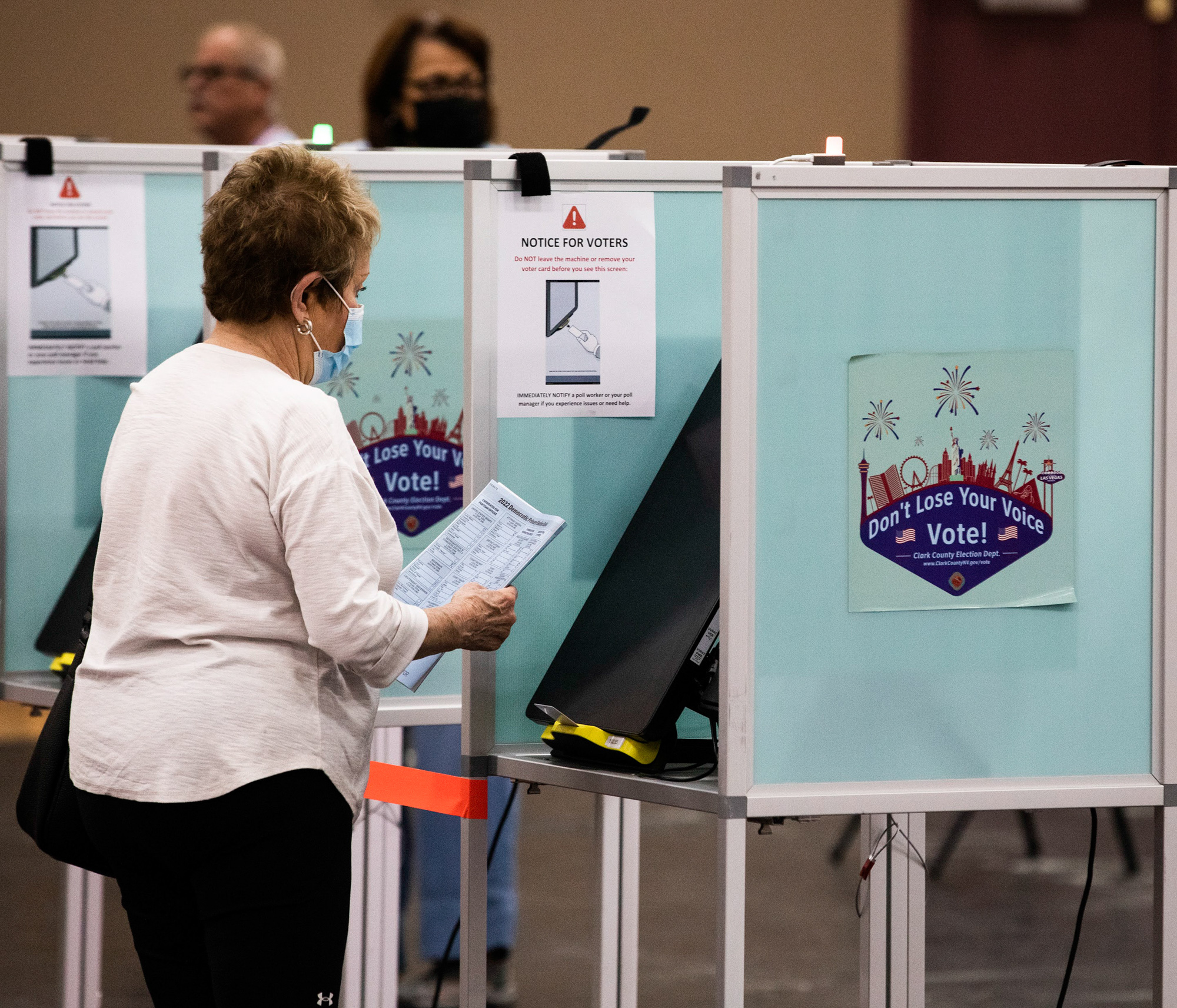A woman looks at a sample ballot on the first day of primary voting in Las Vegas on Saturday, May 28, 2022. (Jeff Scheid/Nevada Independent)